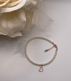 ~ This anklet is an accent to her beautiful princess bridal gown and shoes. The anklet features 4 mm Swarovski crystal pearls and a Cubic Zirconia framed horseshoe. Each anklet is hand-made and made to order ~Please specify white or Ivory Swarovski crystal pearl  ~Rose Gold lobster clasp....comes with 1 inch rose gold extender with blue Swarovski Crystal    ~ Comes with something blue card and may personalize card ~Please let me know the anklet size. To measure for the anklet sizes- wrap a ribbon or string around your ankle, mark it with a pen, measure it and add 1/2" for comfort-loose fit or exact fit  ~Each anklet will arrive in a box tied with a ribbon perfect for gift giving and dust cover pouch ~Please read our policies for information on international shipping, returns, and exchanges Elegant White Heart Bracelet For Party, Elegant Adjustable Anklets With Heart Charm, Silver Anklets For Valentine's Day Party, Elegant White Heart Bracelet For Wedding, Elegant Valentine's Day Party Anklets, Elegant Heart-shaped Anklets For Valentine's Day, Rose Gold Heart Charm Bracelet For Wedding, Elegant Heart Charm Anklets For Valentine's Day, Elegant Heart-shaped Anklets For Party