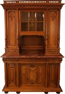 an old wooden cabinet with marble top and doors on the front, inlaid with carvings