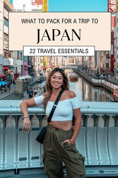 a woman standing on a bridge with the words what to pack for a trip to japan 22 travel essentials