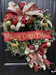 a merry christmas wreath on the front door with ornaments and ribbons hanging from it's sides