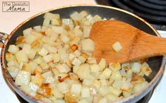 a wooden spoon stirring food in a pan on the stove