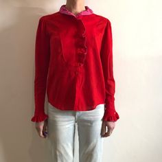 1970s Lovely red and hot pink cotton Kenzo Paris peasant blouse.  Tuck this into high waisted jeans or a skirt and slip on your clogs for a great 1970's boho look.  Fabric is a super fine cotton, slightly sheer.  Great ruffled collar! All the ruffles are double with a pink ruffle on the inside.  The shirt front has a tuxedo type bib.  Gathers at the sleeve caps for full sleeves.  Seven mother of pearl button up the front.  Ruffles at the sleeve cuff with one button. Label Kenzo Paris, Size 40, Made in France, 100% cotton. Please hand wash cool, drip dry.  Very good vintage condition with no fabric or sewing flaws.  Measurements Shoulders 40cm/ 15.5inches Chest 98cm/ 39inches At waist 98cm/ 39inches At hem 94cm/ 37inches Shoulder to hem 62cm/ 24inches Sleeve length 65cm/ 25.5inches Models m Fitted Red Cotton Blouse, Red Cotton Blouse For Daywear, Vintage Red Cotton Blouse, Retro Red Blouse For Spring, Retro Red Spring Blouse, Vintage Red Blouse For Daywear, Retro Cotton Top With Ruffled Collar, Retro Cotton Tops With Ruffled Collar, Kenzo Paris