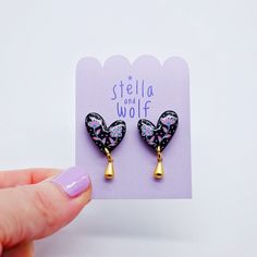 This version of the wonky heart drop earring has a hand painted botanical illustration on in black with pink and white flowers and buds.  To finish, a cute gold plated tear drop hangs from the bottom of the heart.  A coating of resin has been applied to give a high shine finish  The hearts are backed with gold plated posts and butterflies as standard.  These can be upgraded to Stirling silver or gold filled on request for an extra charge.  Please contact me before you place your order to check for availability. To keep your Stella and Wolf jewellery in perfect condition, we recommend that you avoid contact with water, perfume, body lotions and sun creams. Water Perfume, Wolf Jewelry, Body Lotions, Pink And White Flowers, Sun Cream, Heart Drop Earrings, Stirling, Drop Earring, Valentines Gift