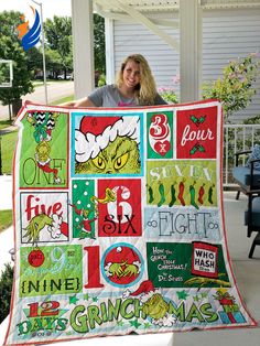 a woman is holding up a quilt that has the grinch on it and other christmas related items