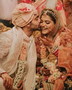 a bride and groom sharing a kiss in front of their guests at the wedding ceremony