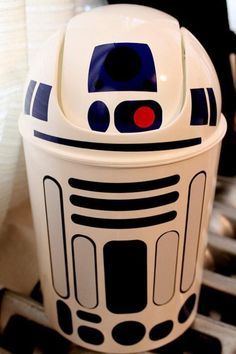 a star wars r2d2 trash can sitting on top of a table