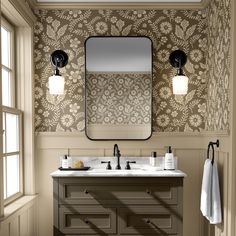 a bathroom vanity with two sinks and a large mirror above it, in front of a window