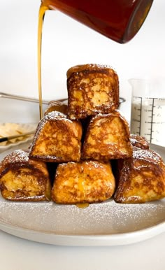 powdered sugar is being poured onto some pastries