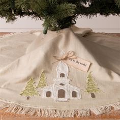 a christmas tree skirt with a small white church on it