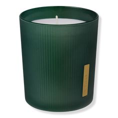 a green candle with a tag on it