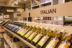 there are many bottles of wine on the shelves in this store, and one is empty