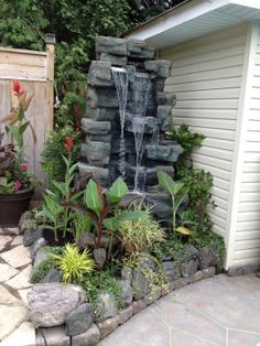 a small waterfall in the middle of a garden