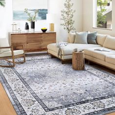 a living room filled with furniture and a large rug