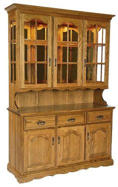 a wooden china cabinet with glass doors on the top and bottom, sitting against a white background