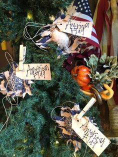 a christmas tree decorated with ornaments and ribbons for the holiday season, including an american flag