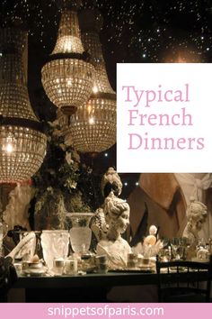 a table topped with lots of fancy chandeliers in front of a christmas tree