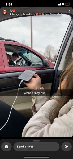 a woman sitting in the driver's seat of a car