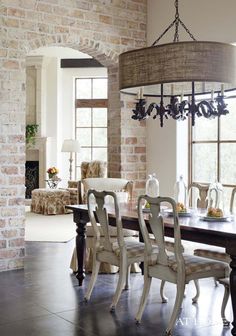 a dining room table with chairs and a chandelier