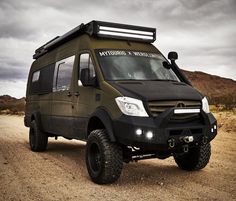 an off - road vehicle is parked in the desert