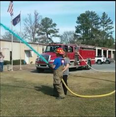 a firefighter is using a hose to extinguish a fire