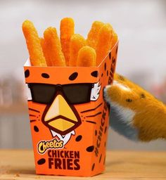 a close up of a box of chicken fries with a stuffed animal in the background