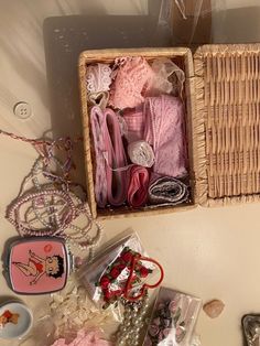 a basket filled with lots of pink items next to other items on a table top