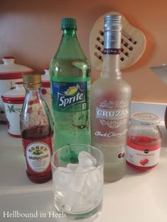 bottles and glasses are sitting on the counter