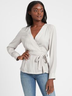 SOFT & SMOOTH: Made with our fluid twill fabric, which has a subtle shine and is easy to care for.  WRAP-EFFECT: An attached belt wraps around the waist to create a wrap-effect.  Low v-neck.  Decorative topstitch detail.  Straight hem.  Unlined.  Semi-fitted.  Long sleeves.  Hip length.  Body length (size S): Petite 25. 5", Regular 26. 5", Tall 28" Sleeve length: Petite 30", Regular 31. 5", Tall 33. 5" Model: Size XS, 5'10" (178cm) Summer V-neck Faux Wrap Blouse, Summer Faux Wrap V-neck Blouse, Elegant V-neck Faux Wrap Blouse, Chic V-neck Wrap Top With Tie Waist, Casual V-neck Stretch Wrap Top, Stitch Fix 2020, Peplum Blouse, Neck Wrap, Current Styles