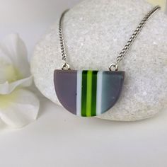 One of a kind handmade fused glass pendant. Simple and elegant modern minimalist style Transparent green gray and with stripes with geometric shape. Size: 30mm x 20mm x 6mm. Cast silver necklace attachments. Incorporates Bullseye opal and transparent glass. Sculpted by hand and fused multiple times. Includes nickle free hypoallergenic 18 inch attached chain. Message anytime with questions. -Sean