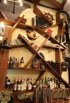 the shelves are filled with liquor bottles and other items