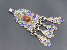 Vintage Moroccan Tuareg hand crafted Sterling silver pendant. Its 100% hand crafted workmanship with Beautiful Coral Stones and unique enamel with tassels design. Please do not hesitate to contact if you have any questions. Measures, Weight : 20.6 grams Length : 8.5cm ( 3.4" ) Width : 2.5cm ( 1" ) Shipping & Estimated Delivery Time With Turkish Registered Post, Destination CountryStandard Shipping (business days) United States          15-20  Europe7-15 Asia15-25  Australia15-20 Brazil & South A Beads Tassels, Coral Stone, Coral Beads, Vintage Moroccan, Sterling Silver Pendants, Silver Pendant, Electronic Accessories, Music Clothes