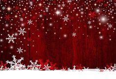 snowflakes and stars on a red wooden background