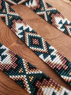 beaded bracelets sitting on top of a wooden table