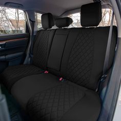 the interior of a car with black cloth and diamond stitching on the seat covers