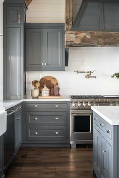 a kitchen with gray cabinets and white counter tops