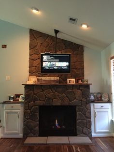 a fireplace with a flat screen tv above it