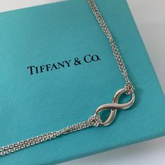 Tiffany & Co. Infinity Pendant - Never Worn! Pendant In Sterling Silver. On A 16" Chain. Comes With Tiffany & Co. Pouch And Box. Tiffany Infinity Is A Powerful Symbol Of Continuous Connection, Energy And Vitality. The Addition Of Endlessly Looped Double Chains Echoes The Infinite Nature Of The Design. Please Let Me Know If You Have Any Questions. Thanks! #Tiffany #Tiffanys #Tiffanyjewlery #Breakfastattiffanys #Littlebluebox #Necklace #Infinity #Infinitypendant Tiffany Infinity Necklace, Necklace Infinity, Jewelry Tiffany, Infinity Pendant, Womens Jewelry, Infinity Necklace, Tiffany Co Jewelry, Double Chain, Jewelry Necklace