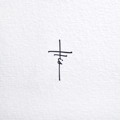 a cross is drawn on the side of a white wall with chinese writing in black ink