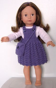 a doll with brown hair wearing a purple dress and white shirt is standing on a shelf