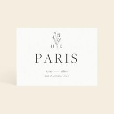 a white card with the words live paris in black ink on it and a floral design