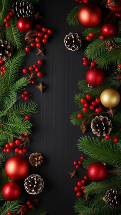 christmas decorations and pine cones are arranged on a black background with red berries, evergreen leaves and gold baubles