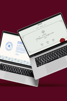 two laptops are open on top of each other, one has a certificate attached to the screen