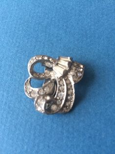 "1940 Art Deco dress clip with rhinestones and silver tone metal. The brooch measures 3 cm x 3 cm (1 1/4\" x 1 1/4\"). The brooch is in very good vintage condition with all stones intact. It has a solid clip on the back of the brooch.  Lovely item of Art Deco costume jewellery." Art Deco Dress, Dress Clip, Silver Tone, Favorite Jewelry, Art Deco, Accessory Gift, Display Homes, Electronic Accessories, Stone