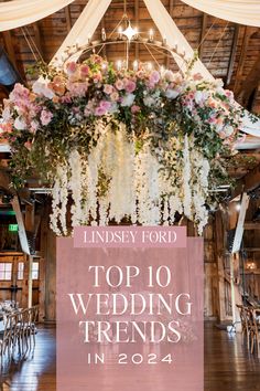 the top 10 wedding trend for 2014 is pink and white flowers hanging from a chandelier