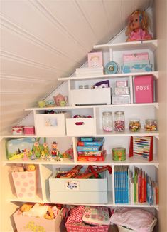 a white book shelf filled with lots of books and other items on top of it