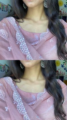 a woman with long black hair wearing a pink sari and matching earrings, posing for the camera