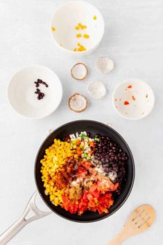 an image of mexican food being cooked in a skillet with ingredients on the side