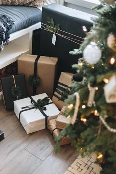 presents under the christmas tree are wrapped in black and white paper