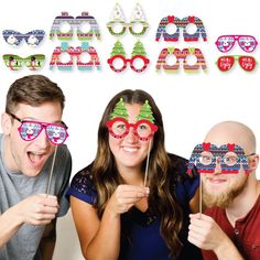 three people wearing christmas themed glasses and masks