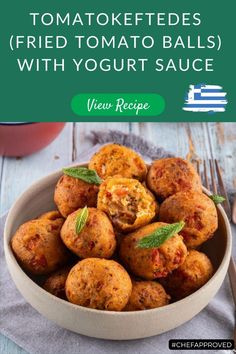 a bowl full of fried tomato balls with yogurt sauce in it and the title overlay reads